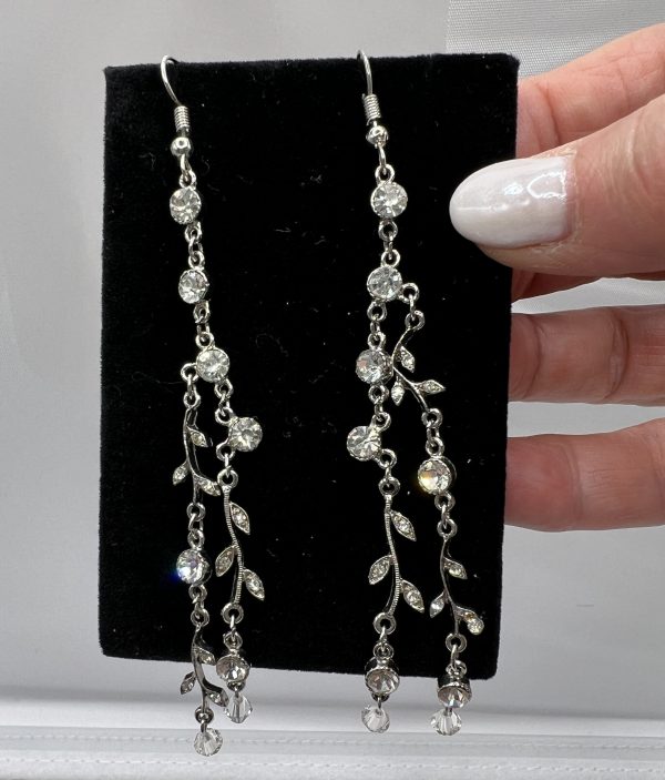 hand holding leaf and vine earrings 2